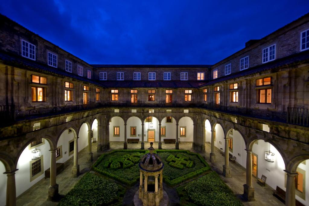 One of several stone courtyards inside a large historic building, with arcades on two levels